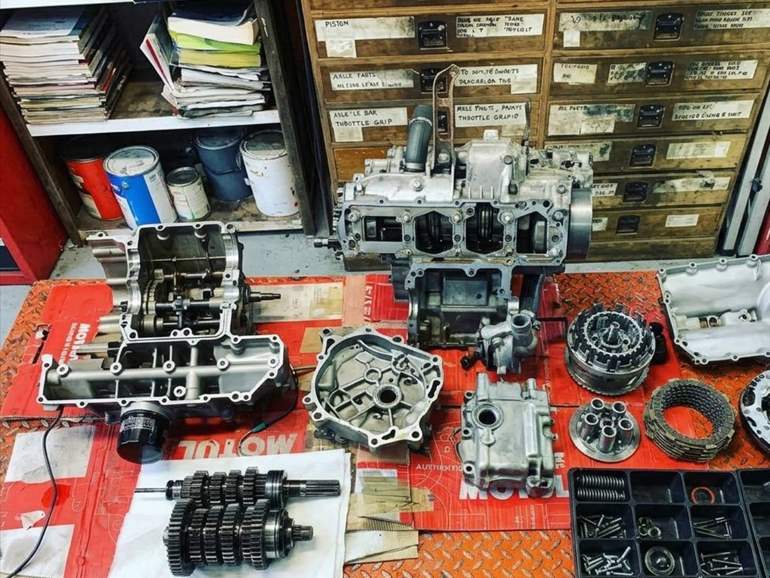 Crankcases, clutch and gearbox laid out during an engine rebuild