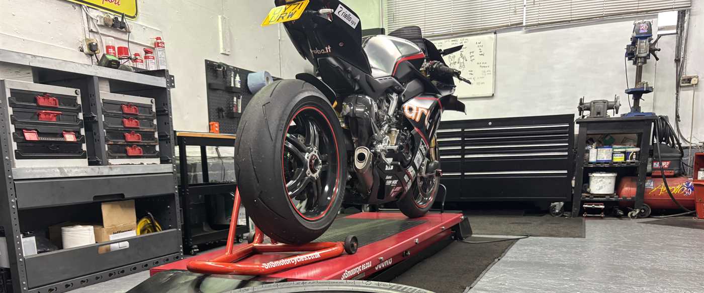 A Ducati on the lift inside the SNS Motorcycles workshop