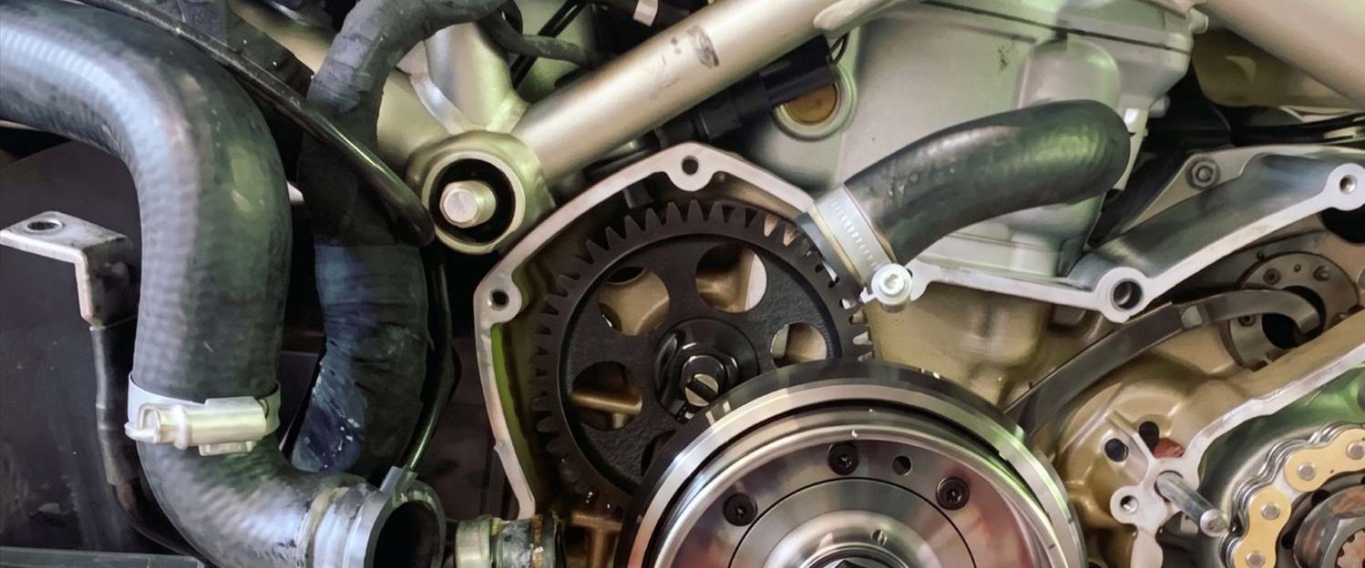 Clutch, cases and chain drive exposed on a stripped Ducati during repair work