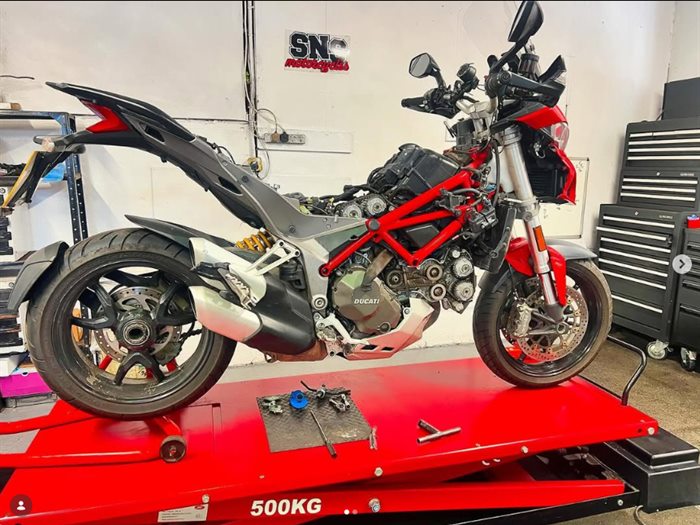 Ducati on the lift at SNS Motorcycles with the belt covers off