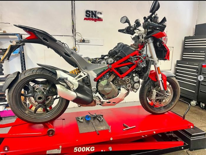 Ducati on the lift at SNS Motorcycles with the belt covers off