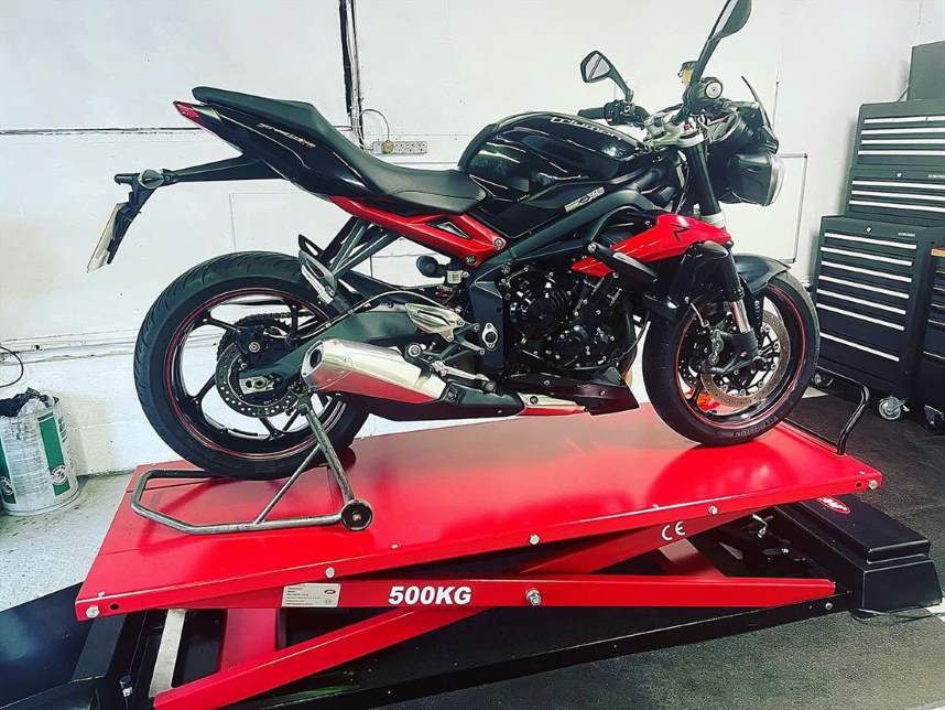 Triumph Street Triple on the workshop lift