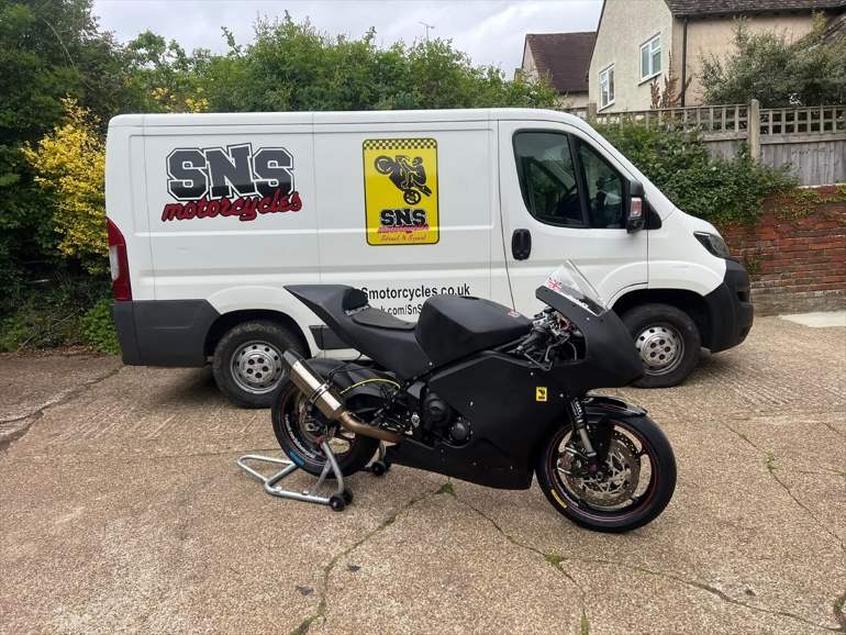 SNS Motorcycles collection van with a race bike alongside